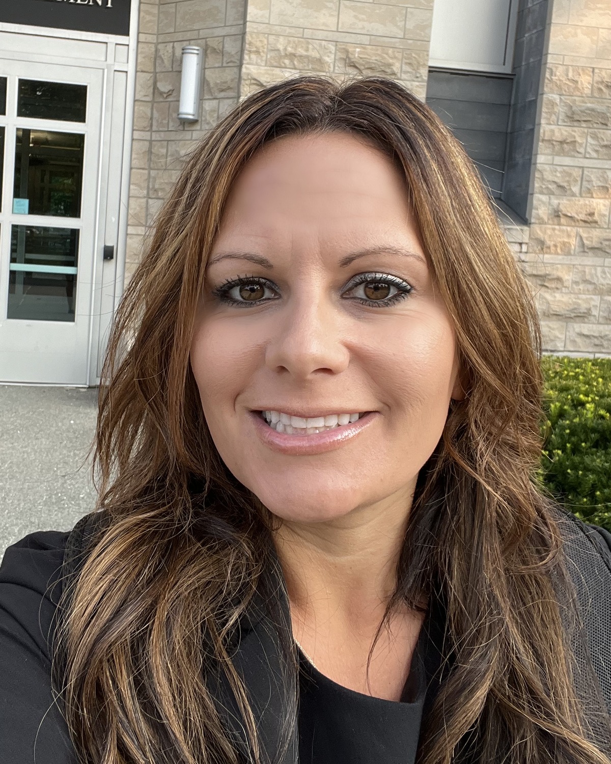 Leah Hanlon, your childcare business advisor, smiling outdoors